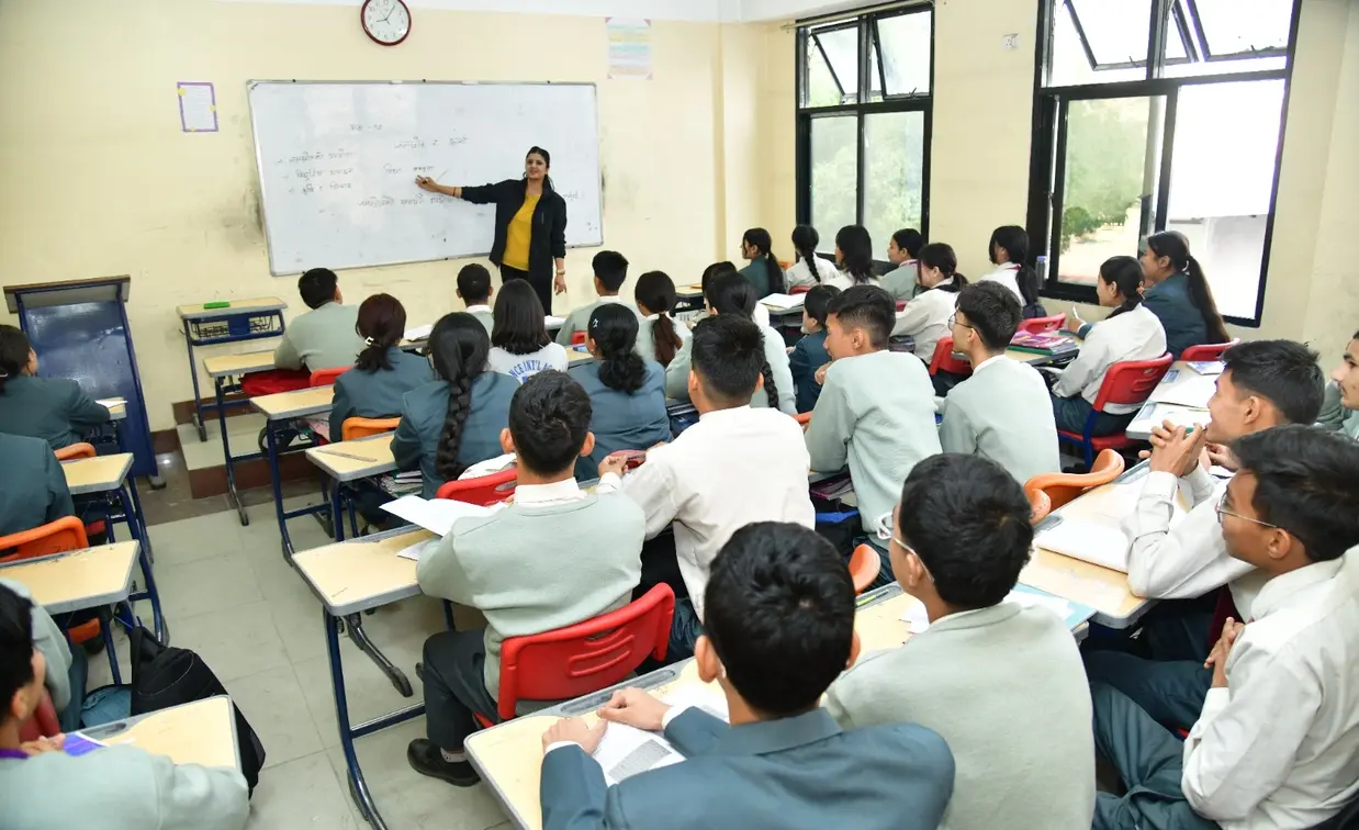 Management students studying economics at college